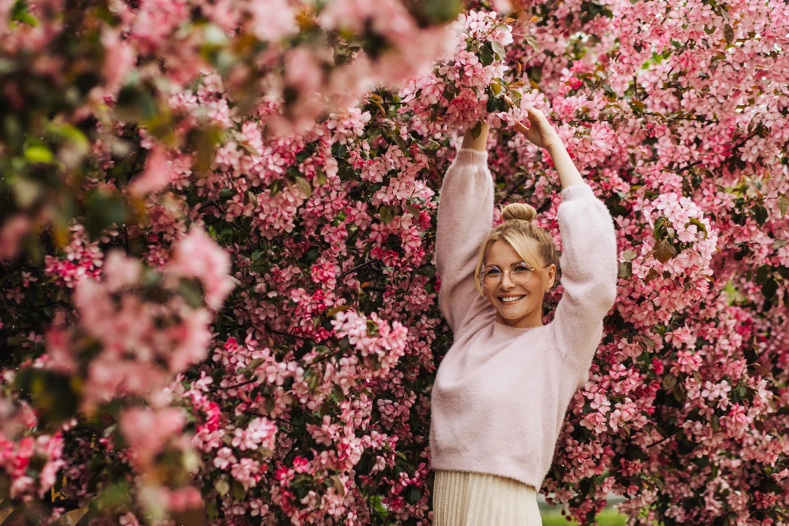 A person enjoying a quiet moment among flowering trees